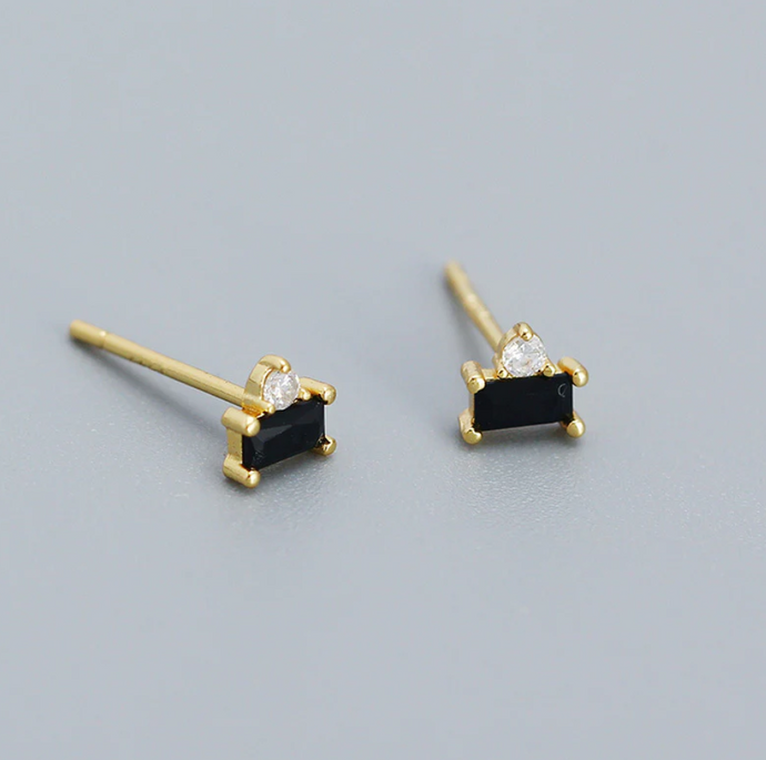Close up of Aria CZ studs, with black gems and gold vermeil setting