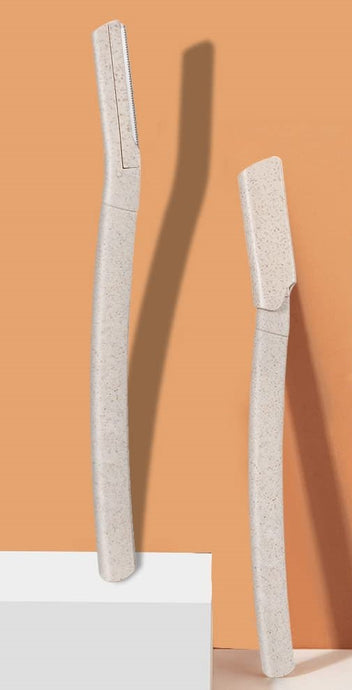 Two biodegradable dermablade razors displayed with orange background