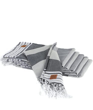 Load image into Gallery viewer, Six grey striped turkish towels folded atop one another displayed on white background
