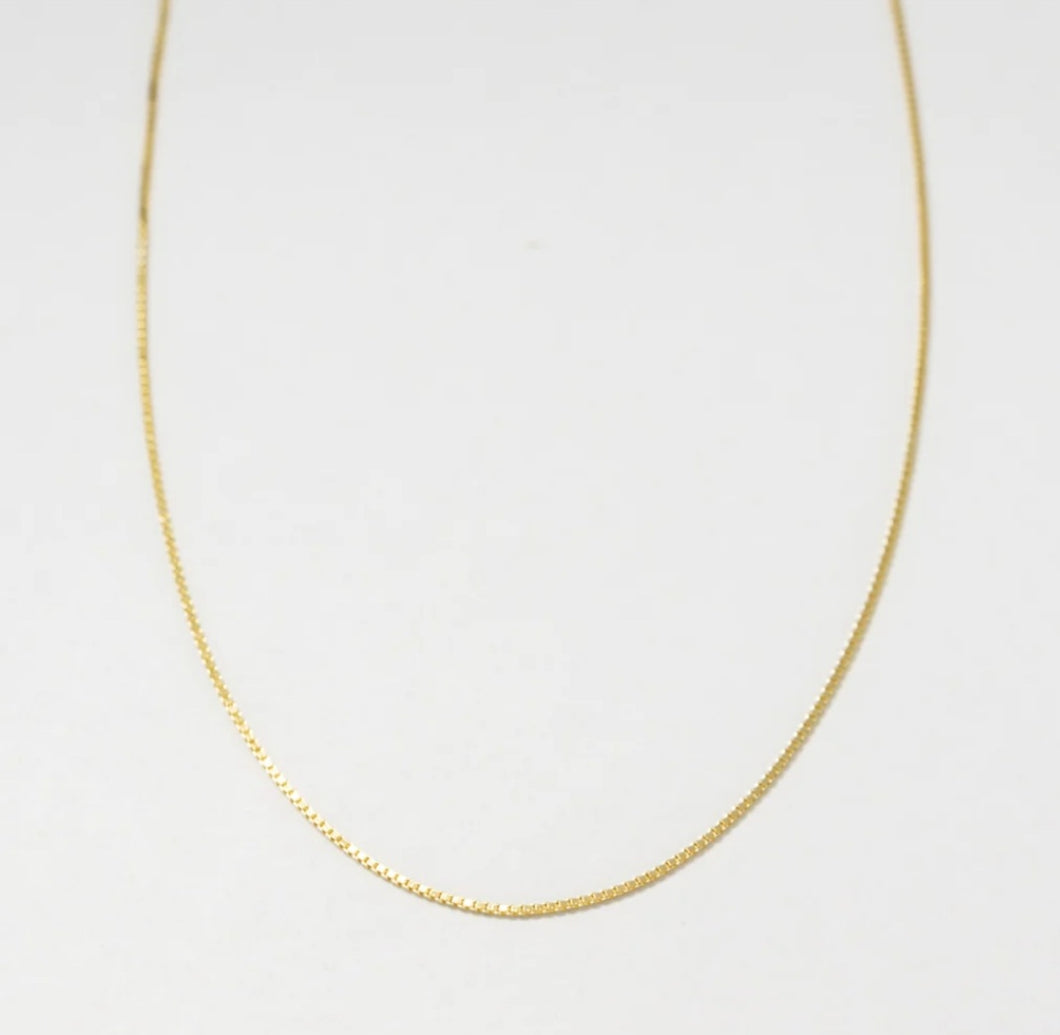 Close up of baby box chain necklace in gold vermeil