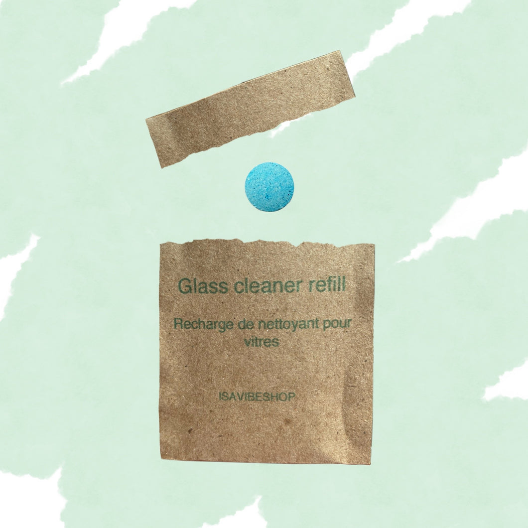 Glass cleaner refill tablet displayed with opened biodegradable packaging on green abstract background