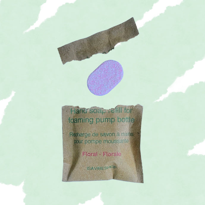Foaming hand tablet and opened biodegradable packaging displayed on green abstract background